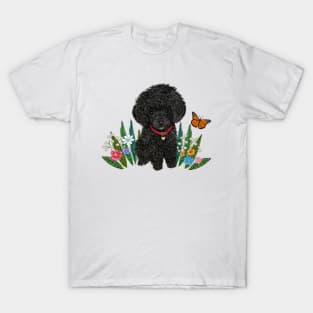 Black Fluffy Poodle Sitting on Grass with Flowers T-Shirt
